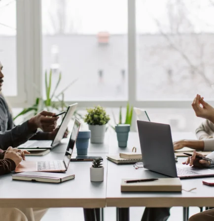 four coworkers talking at the table, working together (1)