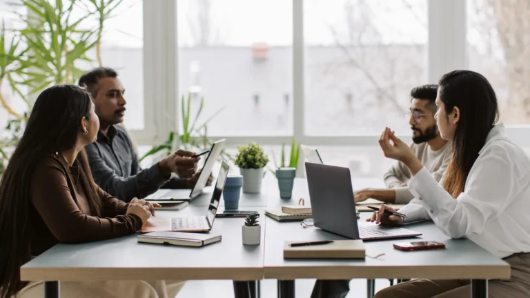 four coworkers talking at the table, working together (1)