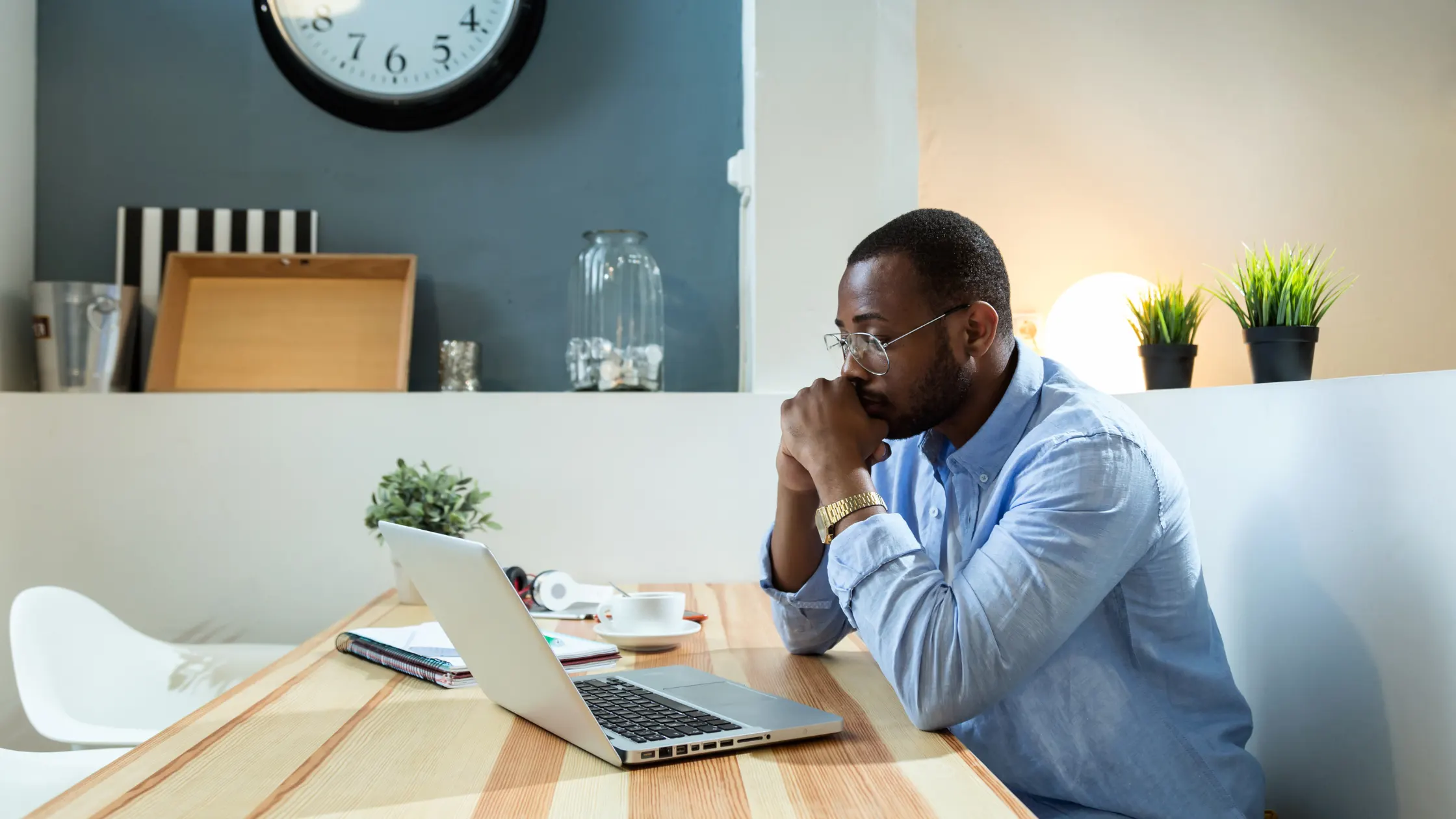 man looking at laptop, deep in thought