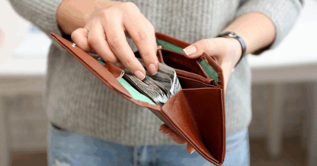 Featured photo of person holding an open wallet full of cash