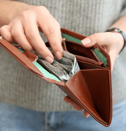 Featured photo of person holding an open wallet full of cash