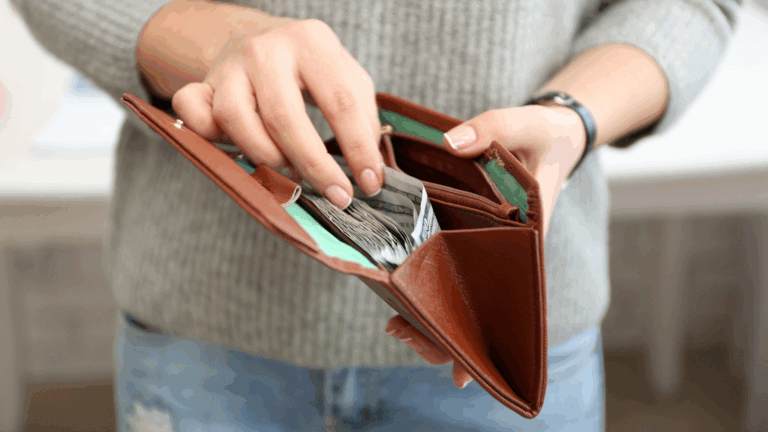 Featured photo of person holding an open wallet full of cash