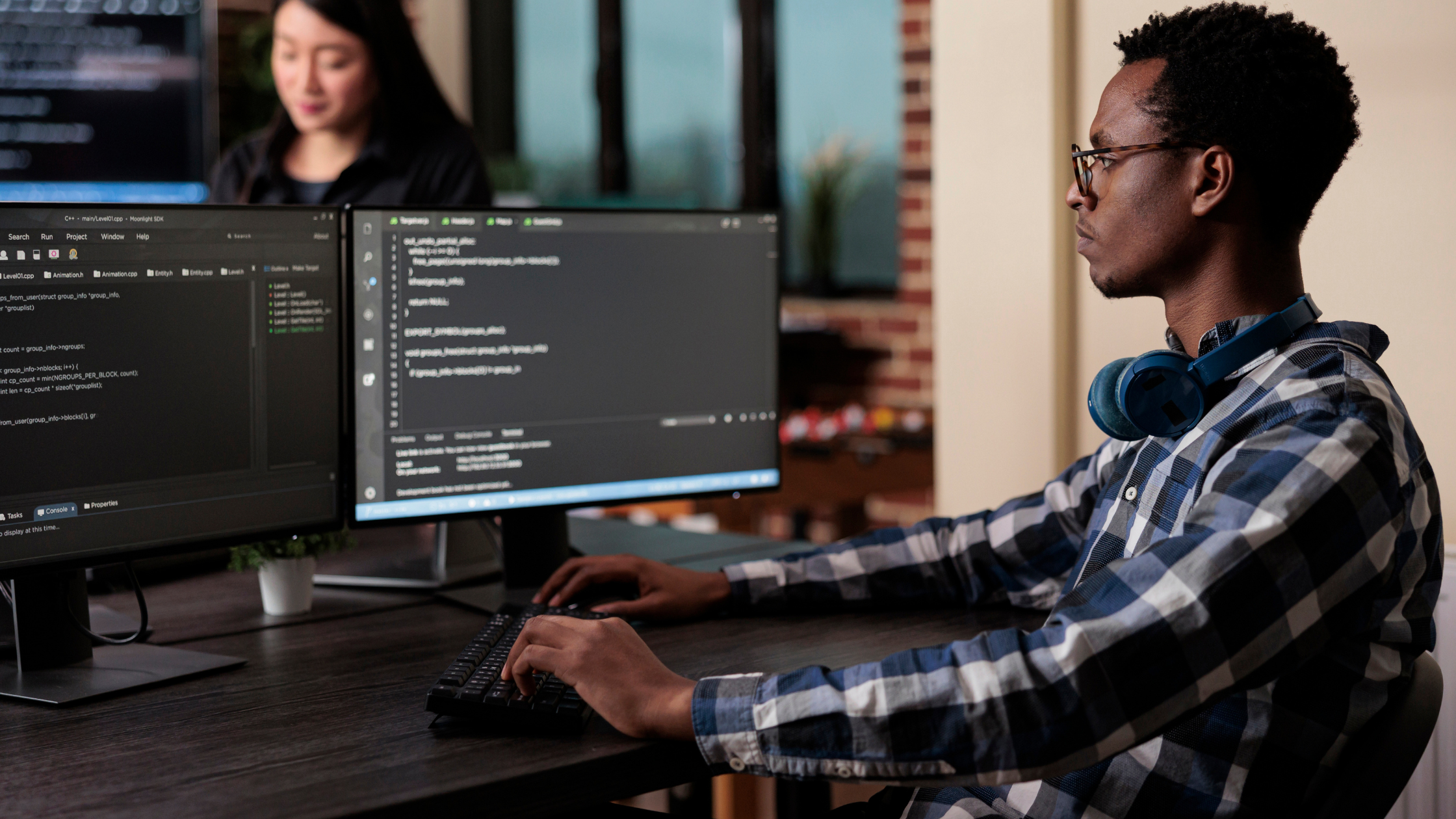 Male working on dual monitors.