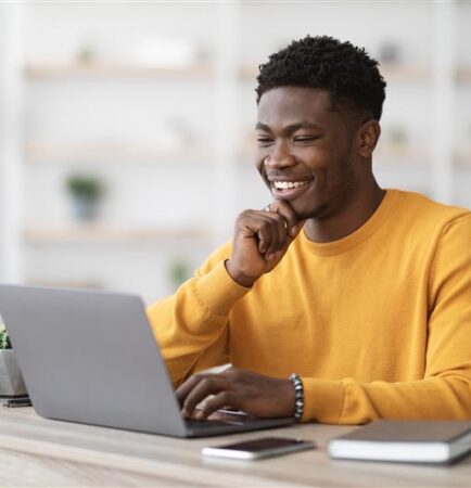 A professional working at a computer, symbolizing HITRUST certification and data security compliance.