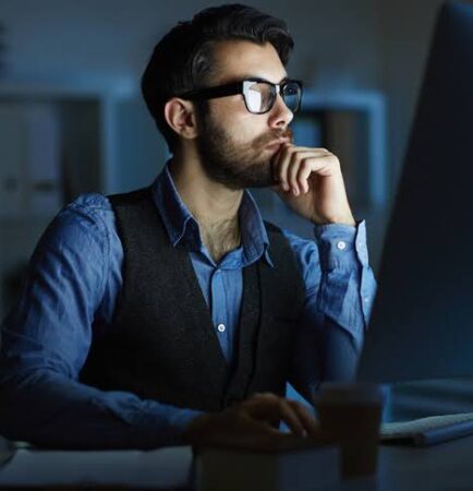 A professional working at a computer, symbolizing HITRUST certification and data security compliance.