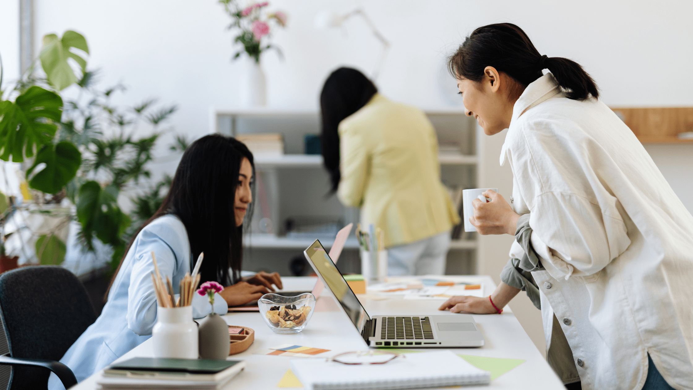 Two females talking across a desk